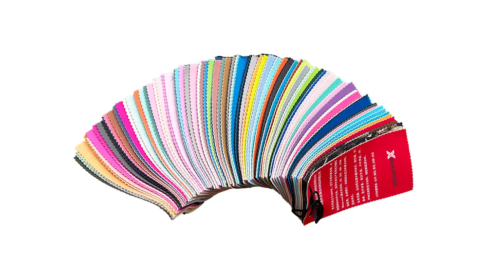 A fanned-out color swatch book displaying over 300 existing colors of Polyester Neoprene Fabric available for immediate lamination.