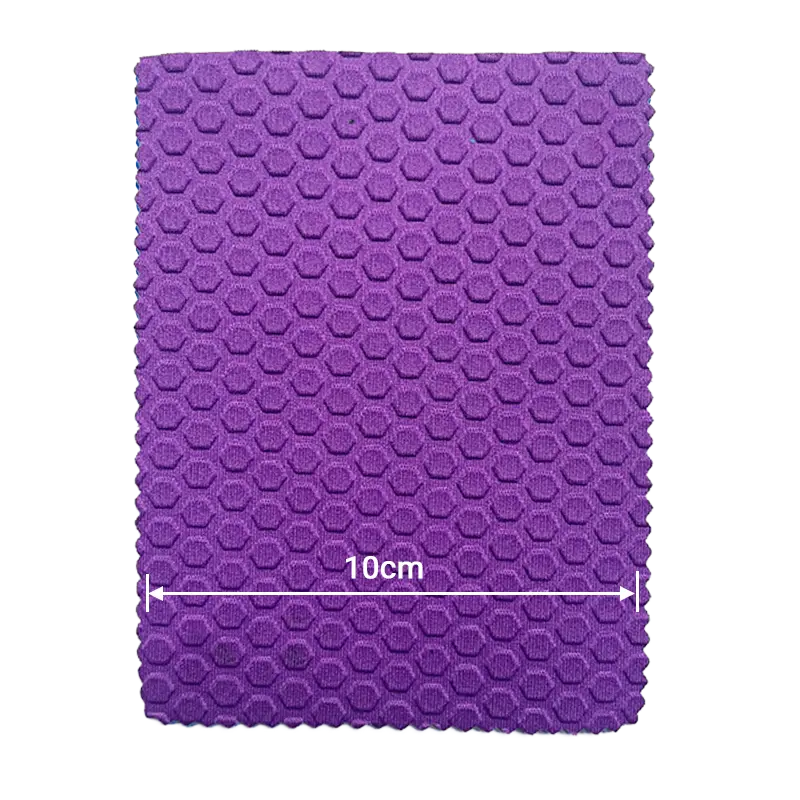 Close-up of purple hexagonal honeycomb embossed neoprene fabric for technical material engineering.