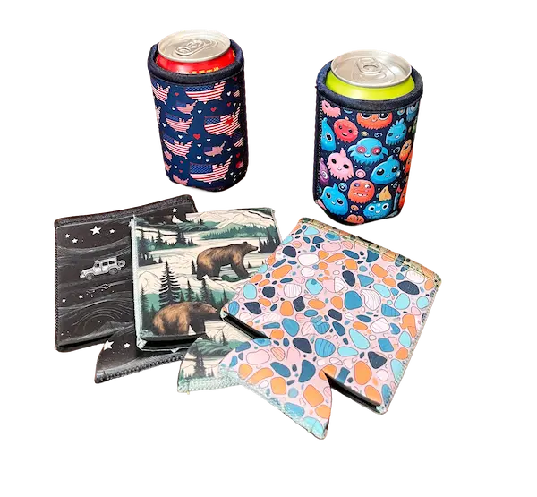 A collection of standard 10cm neoprene can koozies, illustrating how under-sized generic sleeves leave pro-grade 24oz sports bottles unprotected and designs looking half-finished.