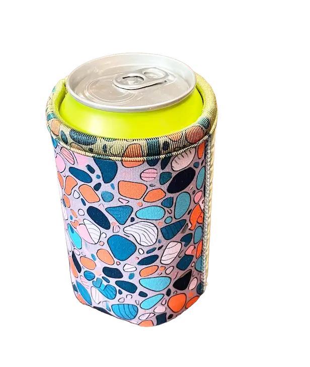 Close-up of high-fidelity 300+ DPI sublimation printing on a custom neoprene can cooler, showing reinforced 4-needle 6-thread flatlock stitching for maximum durability.