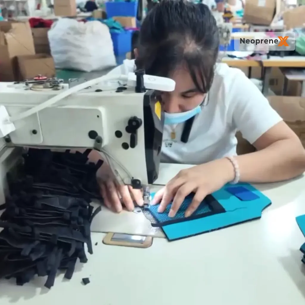 Professional seamstress at Flame Bright Manufacturing using an industrial sewing machine for reinforced stitching on NeopreneX compression gloves to ensure zero seam failure under 15-25 mmHg load.