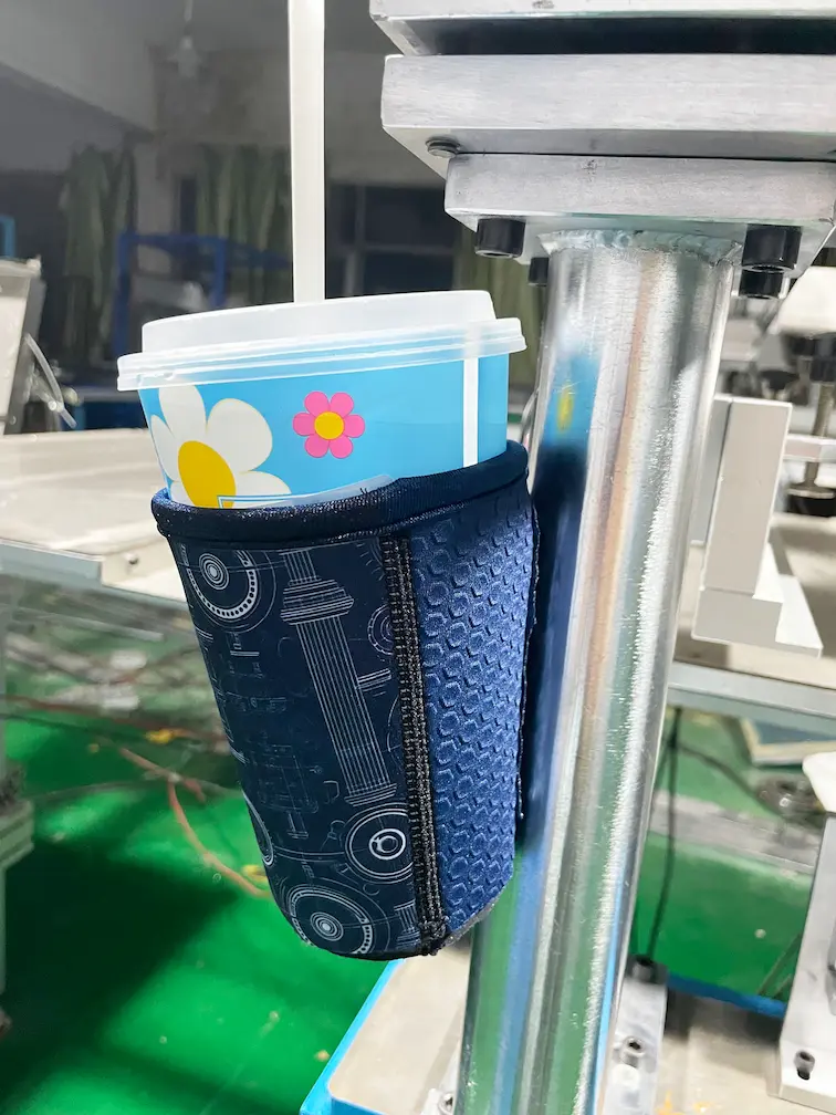 N52 magnetic neoprene coffee sleeve securely attached to a gym rack, demonstrating hands-free convenience for fitness enthusiasts.