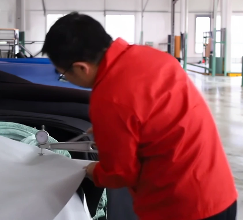 A lead auditor performing a precision thickness check on neoprene fabric using a high-accuracy gauge to verify the ±0.1mm tolerance required for NeopreneX compression gloves.