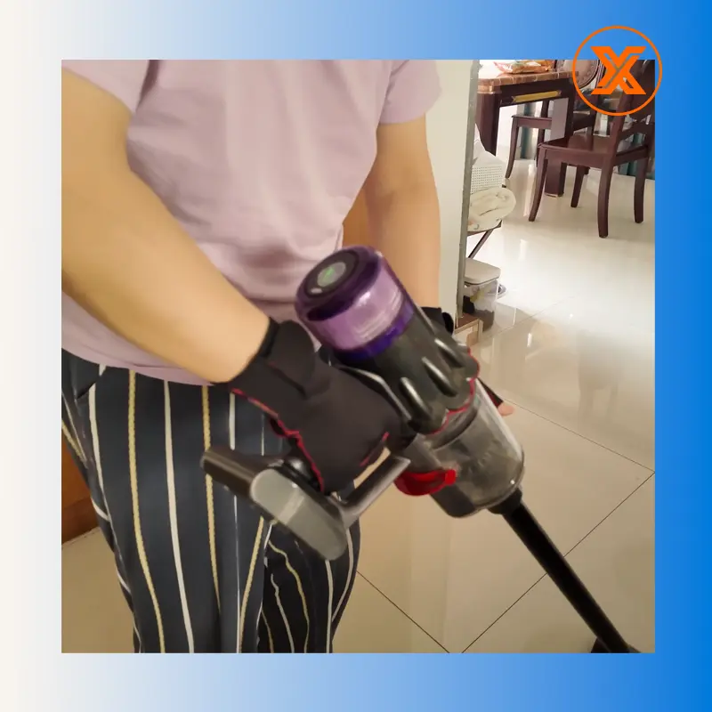 Using a vacuum cleaner with NeopreneX 1.5mm SCR compression gloves to provide an ergonomic power grip and joint stability during housework.