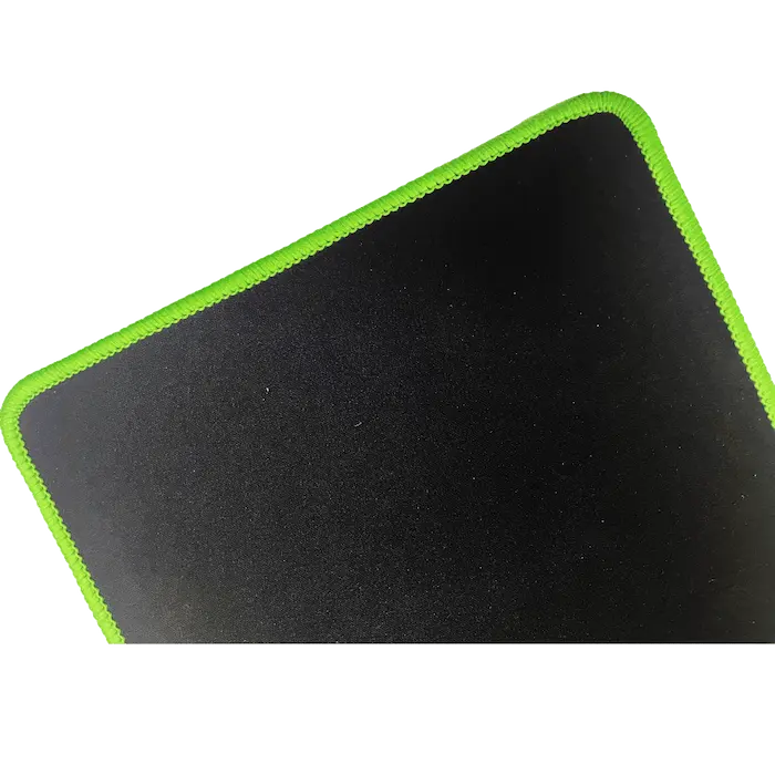 Traditional overlocked edge on a black neoprene mat showing exposed rubber core and visible green stitching threads.