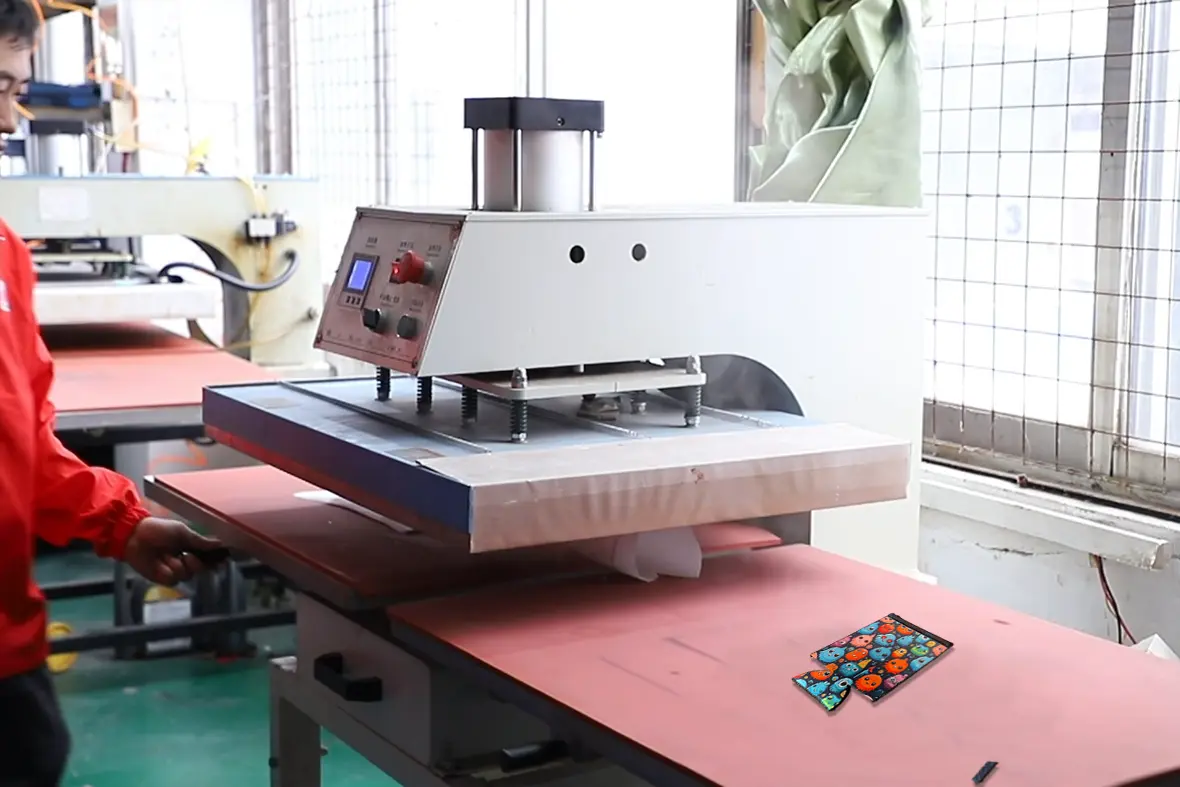 High-fidelity monster pattern sublimation result on the heat press bed, demonstrating the 100% color vibrancy and zero rubber-core bleed-through of our premium blanks.