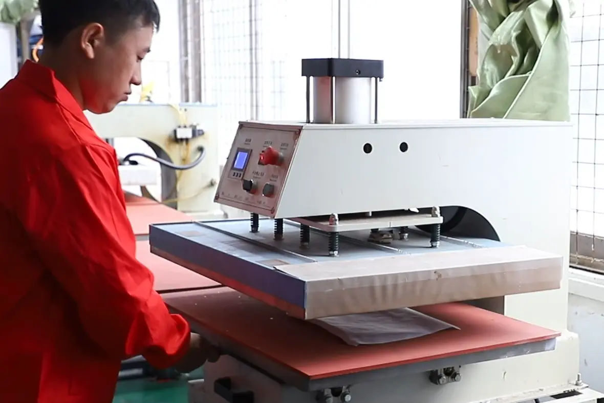 A professional technician using a heat press on white neoprene coffee koozie blanks, testing the 210°C heat resistance and 4-way stretch of our universal 16oz-24oz sleeves.