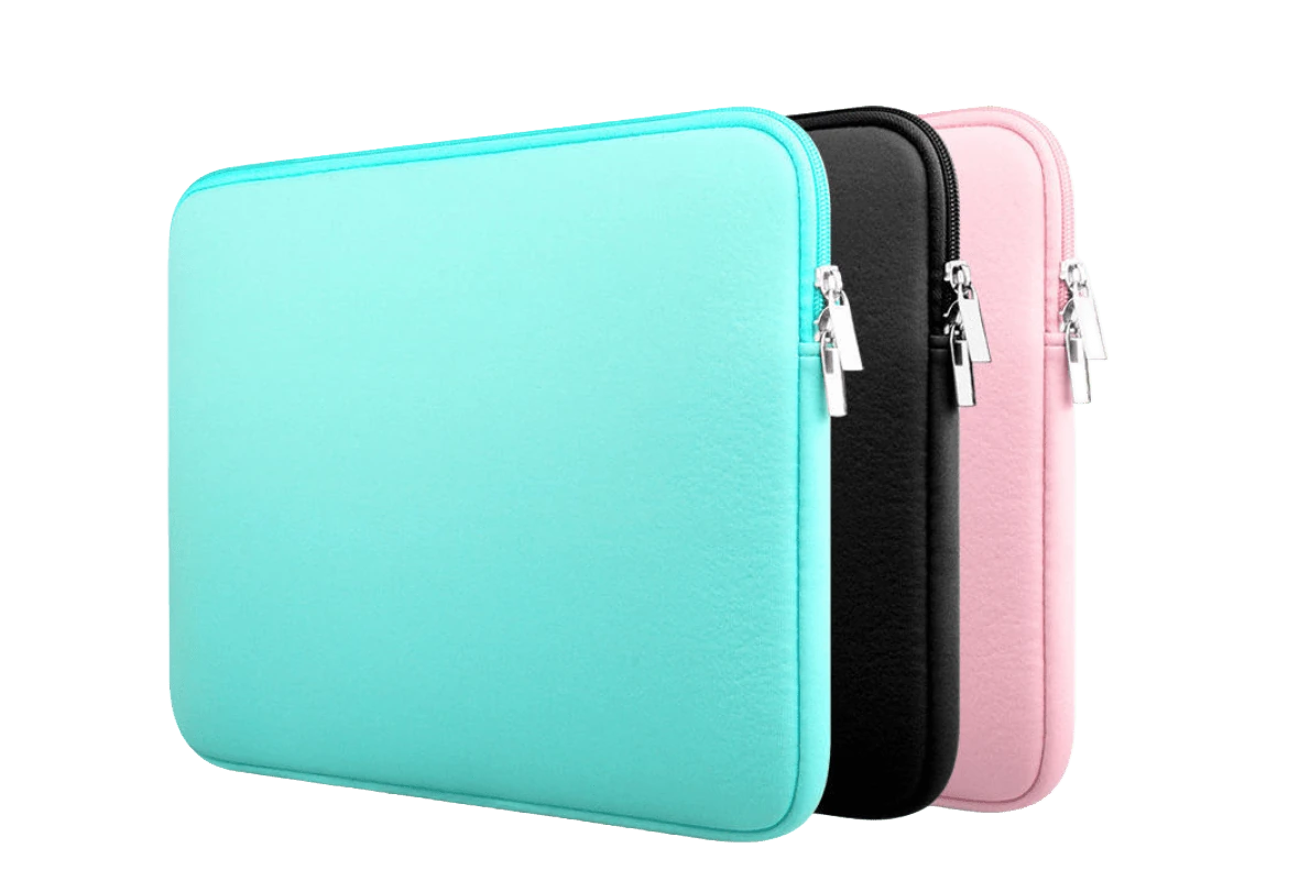 A stack of three classic plain zippered neoprene laptop sleeves in mint green, black, and pink, showing the metallic zipper pulls and padded structured profile for bulk wholesale.