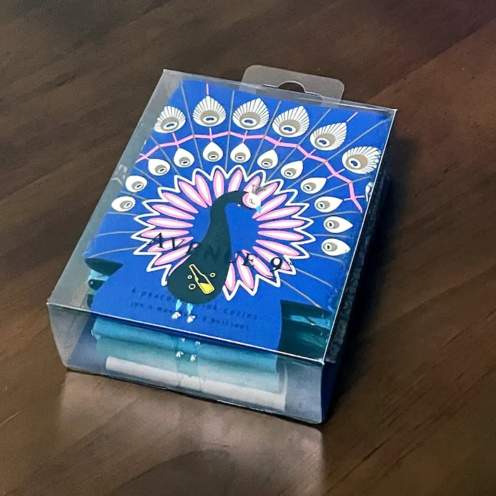 NeopreneX custom full-surface sublimation printed peacock pattern can koozies, 4-pack bundle enclosed in a crystal-clear rigid OPP display box with an integrated Euro hang hole for pegboard retail display.