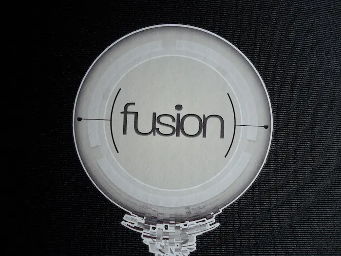 Offset heat transfer printed AMD logo on black Lycra neoprene sleeve with white anti-migration barrier layer – clean, sharp white text with no color migration or edge shadow.