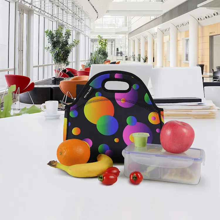 Wholesale colorful polka dot neoprene lunch bag with fruit and food container on office desk, custom OEM ODM manufacturer supply.
