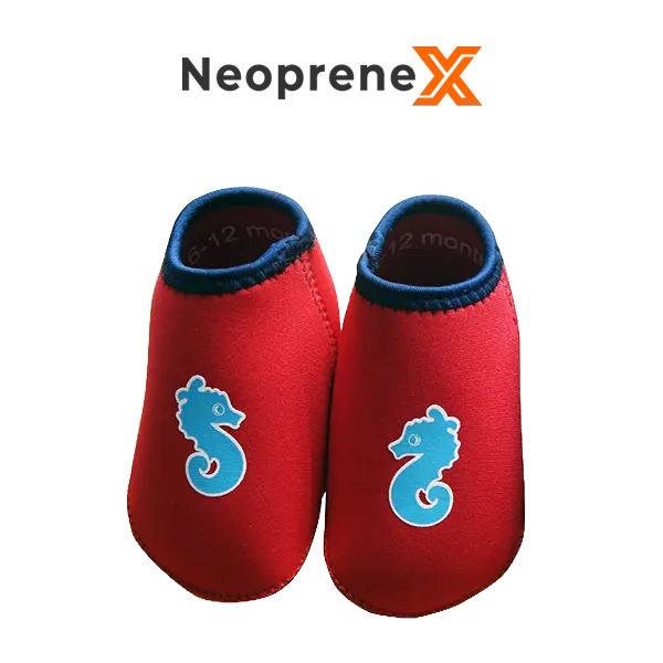 A pair of blue NeopreneX toddler water shoes with light blue seahorse graphics, featuring a 2mm nylon-laminated neoprene upper and SCR embossed non-slip soles. Ideal for babies and toddlers in pools and beaches.