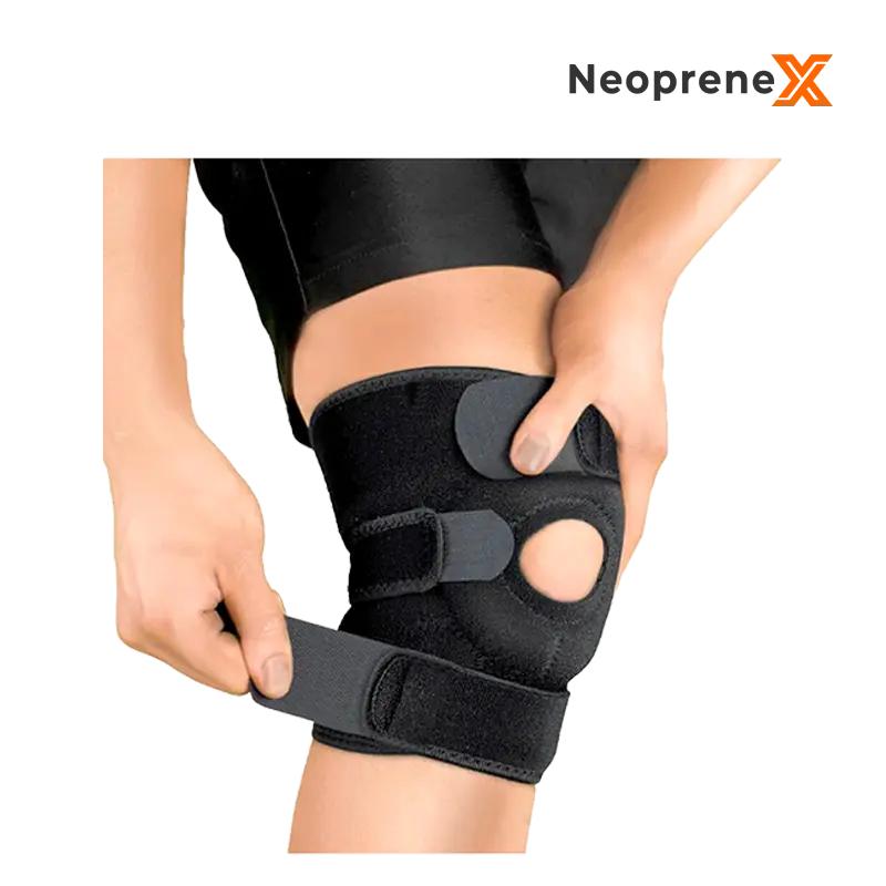 A model adjusting the Velcro straps of the Open Knee Wrap, highlighting the open-patella ring design with reinforced padding for customized tightness.