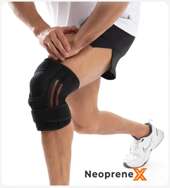 Close-up of a premium neoprene knee brace showcasing the built-in dual flexible side stabilizers through orange mesh, along with adjustable compression straps for maximum joint stability, designed for B2B wholesale buyers.