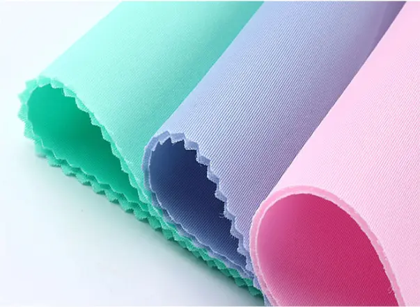 Padded polyester spacer fabric material with knitted outer surface