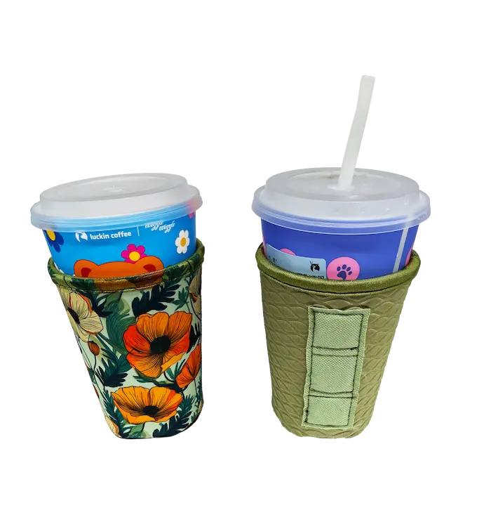 Custom neoprene coffee koozie with floral print and adjustable hook-and-loop closure, shown on takeaway coffee cups.